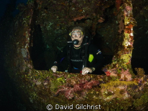 Diver exits Truk Lagoon wreck. by David Gilchrist 
